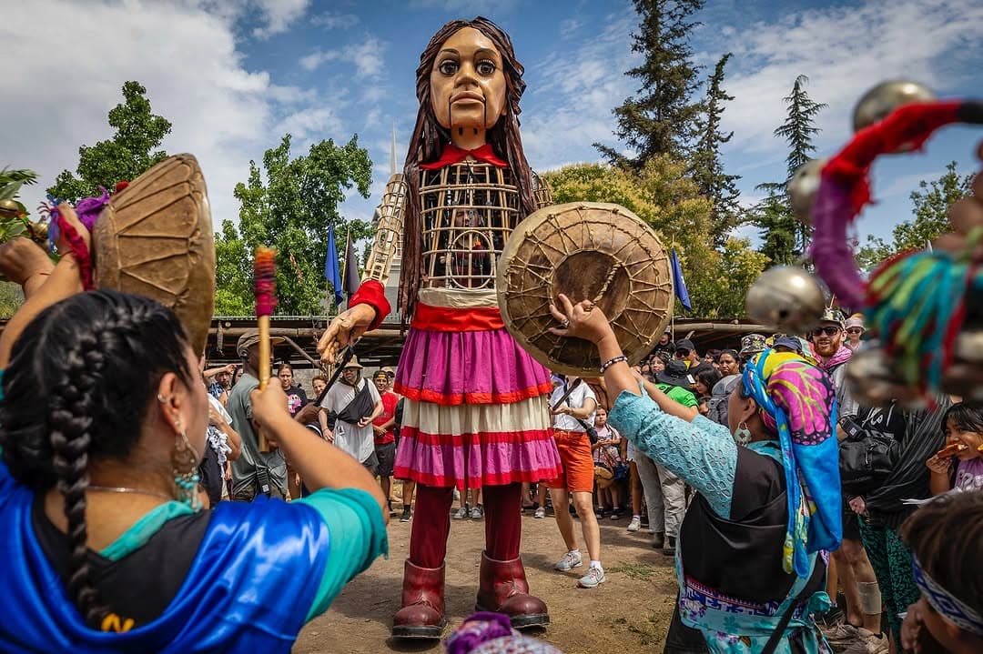 A vibrant street performance during Santiago a Mil with actors in costume and a captivated audience