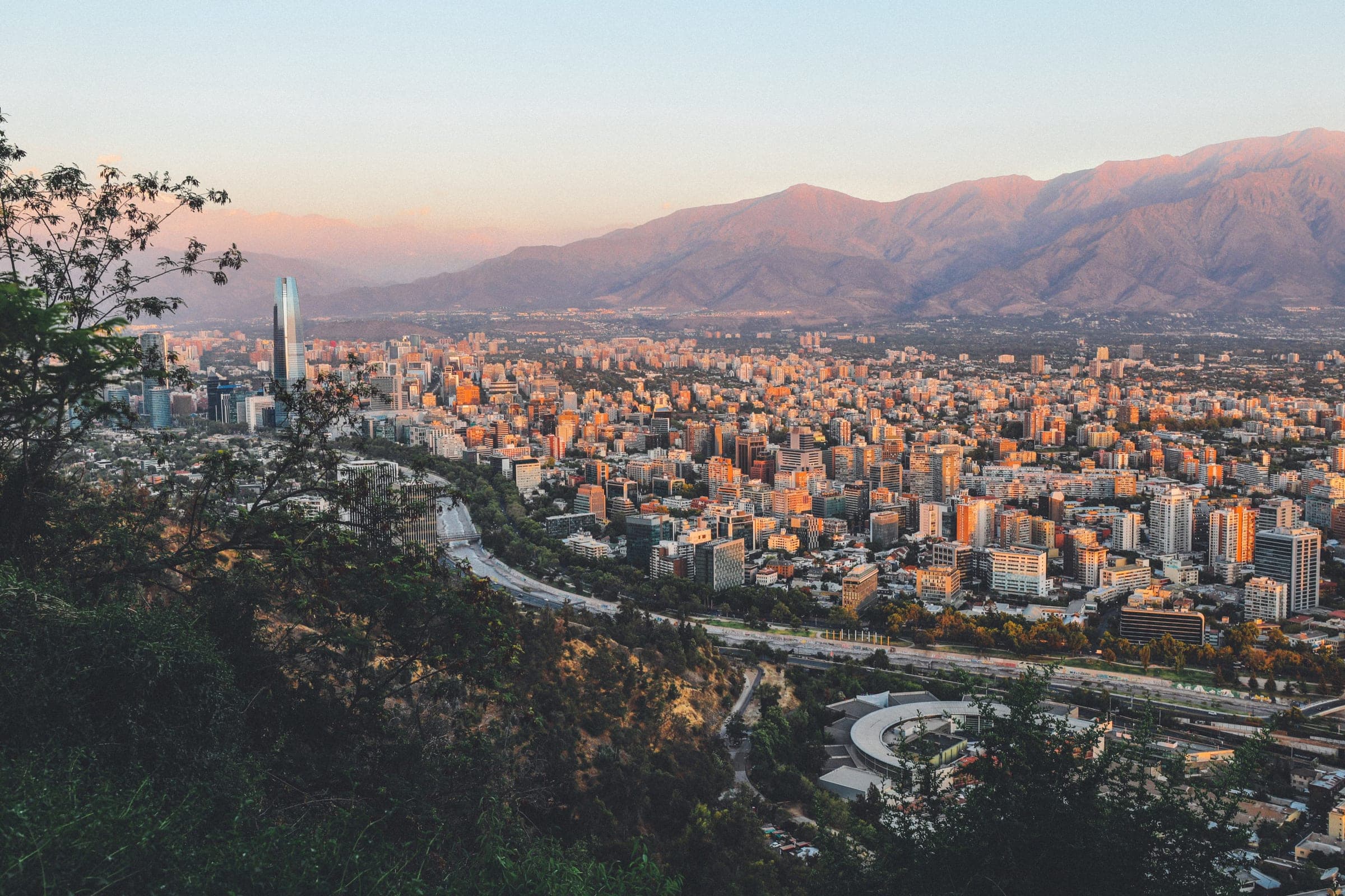 Breathtaking view of Santiago, Chile's skyline framed by mountains at sunset