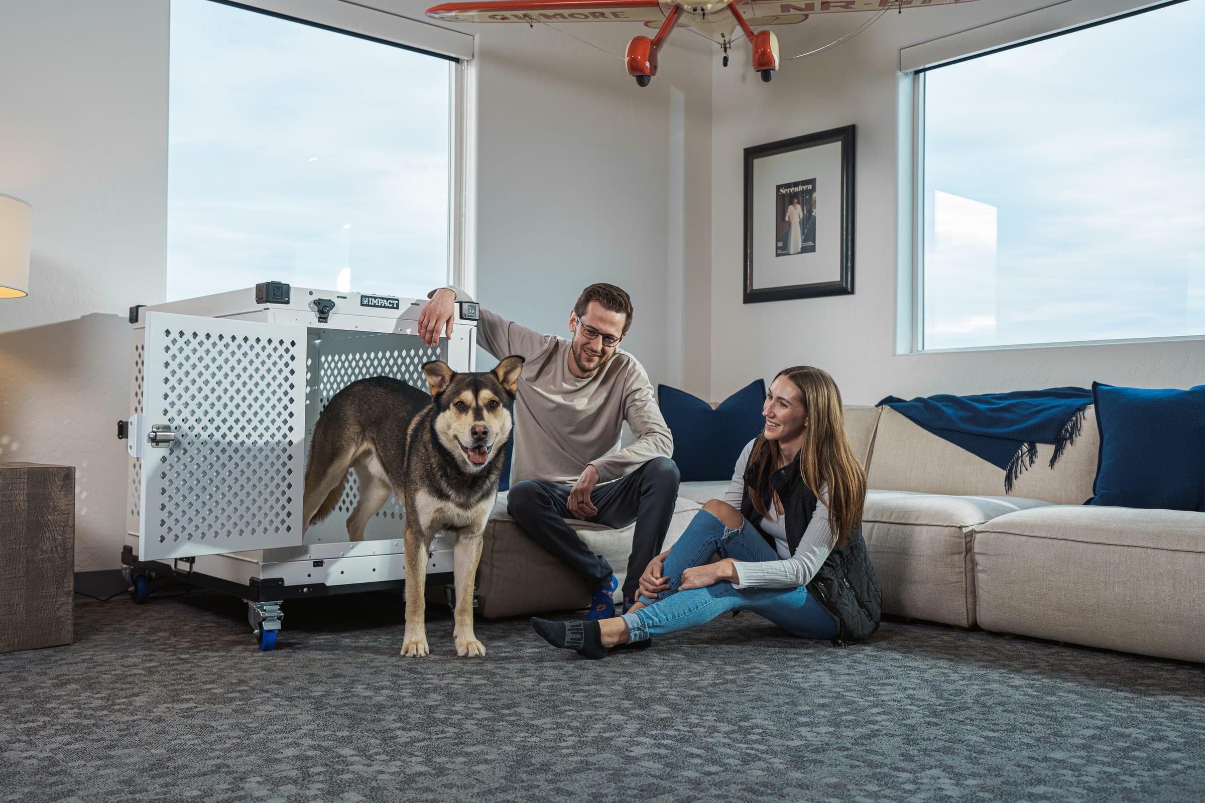 Cozy living room with couple and dog, showcasing comfort and pet-friendly lifestyle